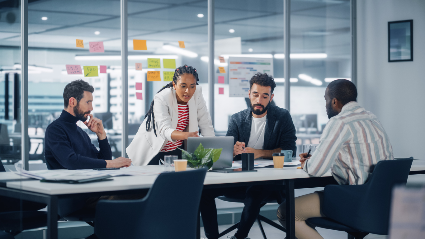 Diverse Modern Office: Successful Motivated Black Businesswoman Leads Meeting, talks of Company Growth. Digital Entrepreneurs Work on e-Commerce Project. Multi-Ethnic People Brainstorming.